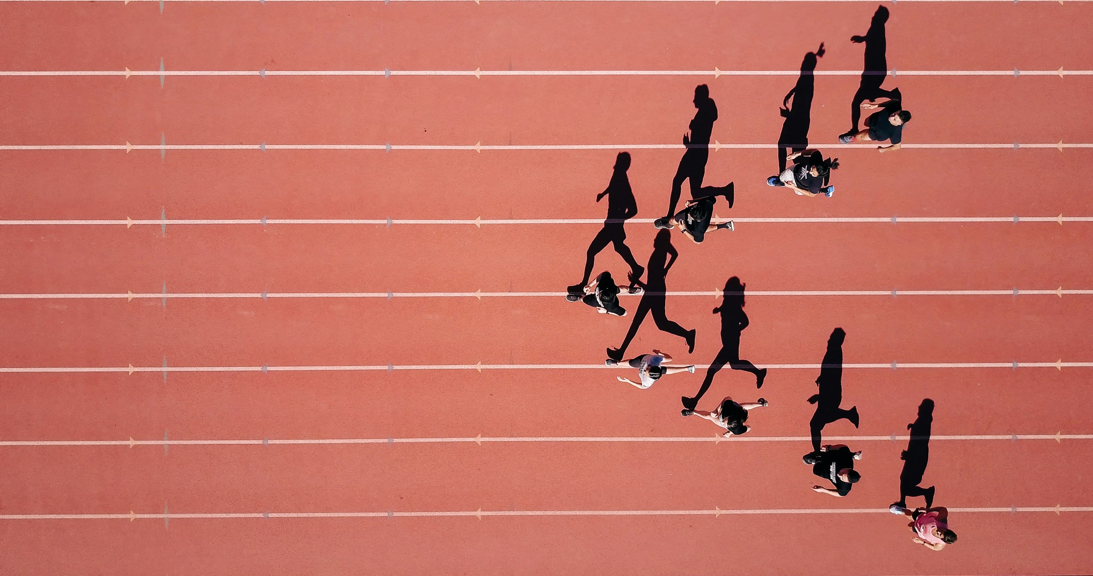 A group of runners gathering on a city street at dawn
